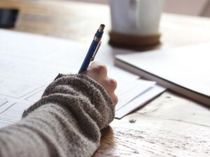 woman writing on paper